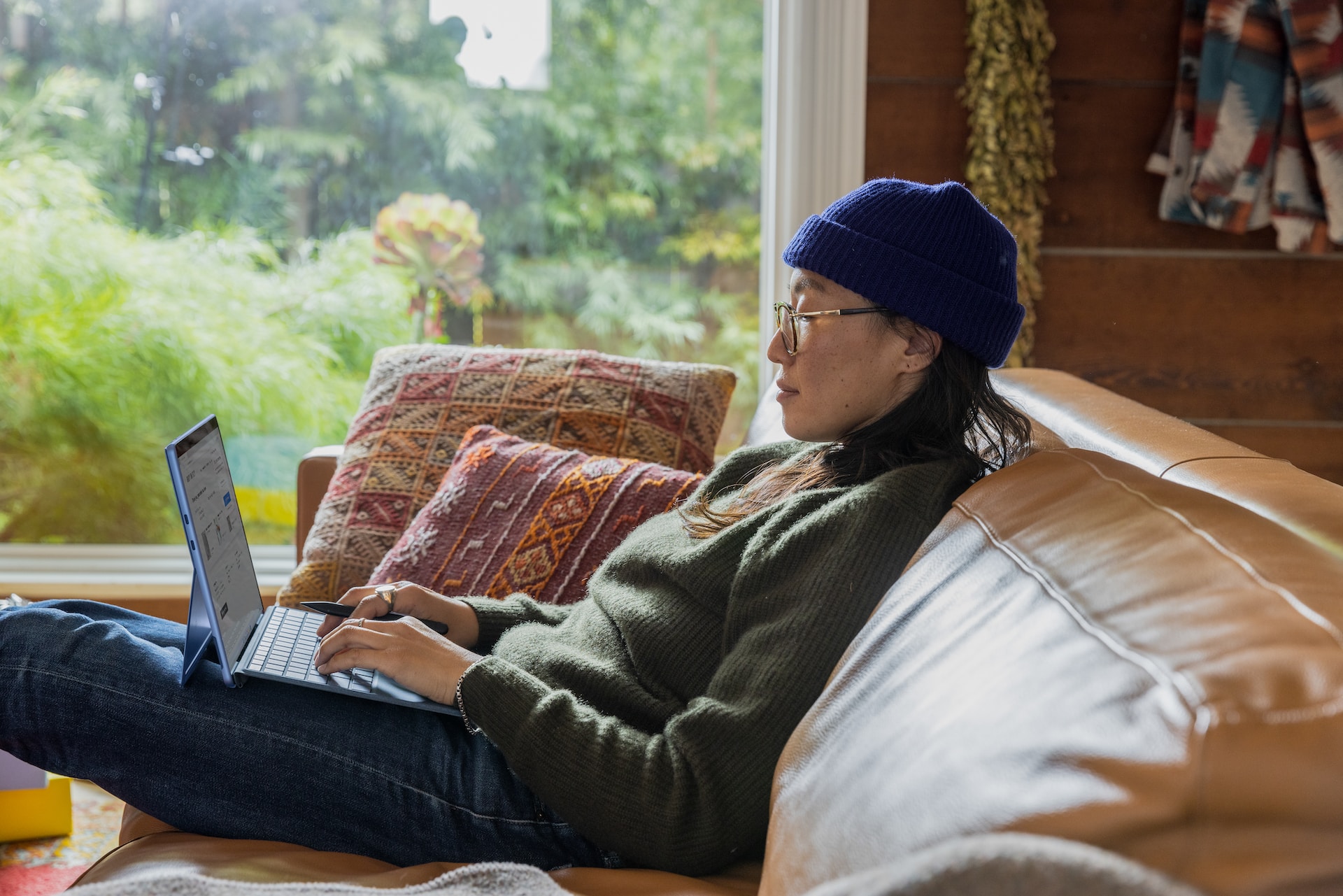Man sitting on Sofa using Rented Laptop